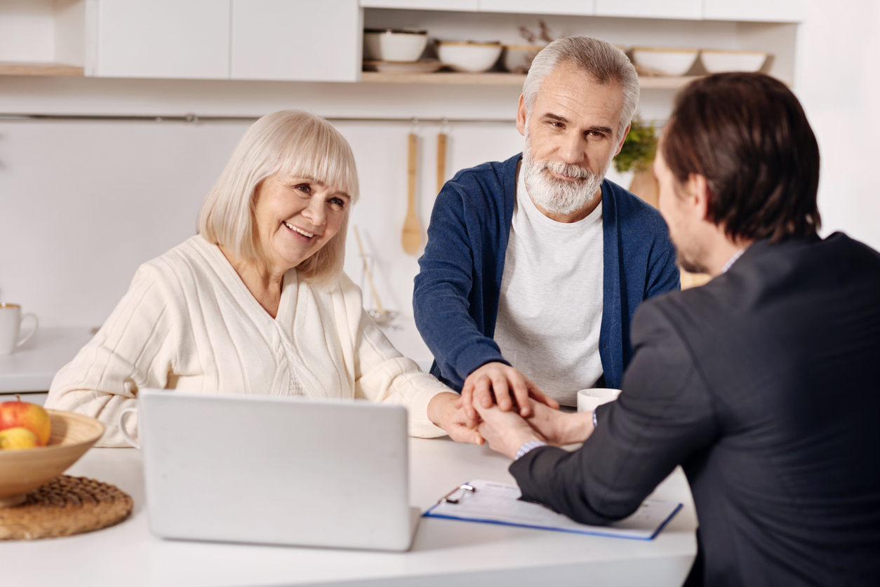 elderly couple consulting local agent