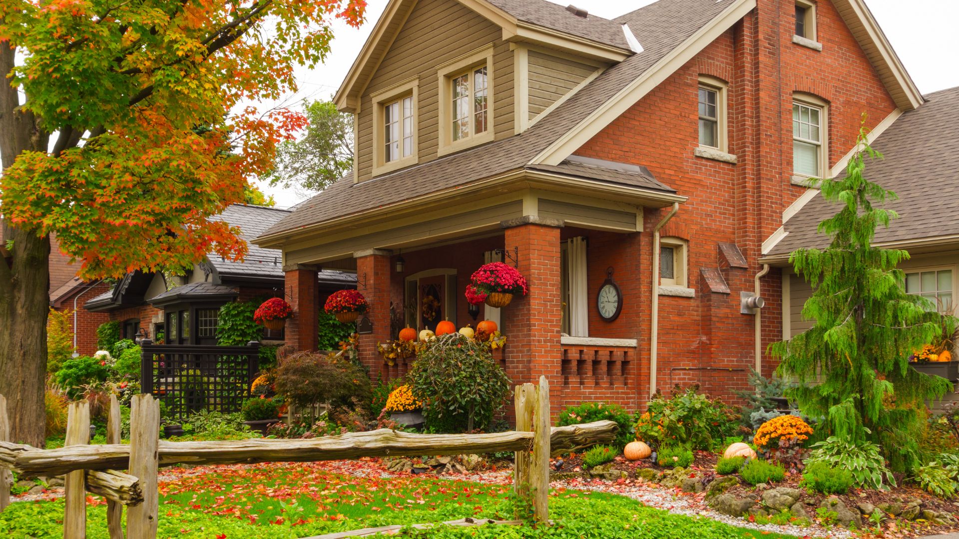 Red house surrounded by autumn foliage, representing home insurance in Columbia County, New York