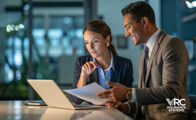 two agents discussing insurance crm solutions