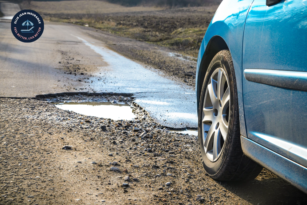 Damage in car caused by pothole in road 